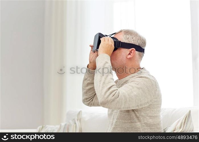 technology, augmented reality, gaming, entertainment and people concept - senior man with virtual headset or 3d glasses playing videogame at home