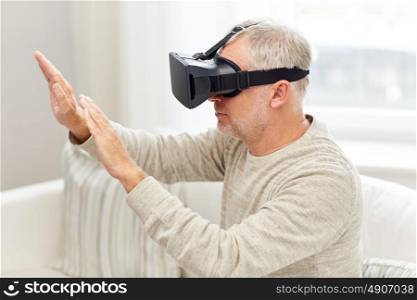technology, augmented reality, gaming, entertainment and people concept - senior man with virtual headset or 3d glasses playing videogame at home. old man in virtual reality headset or 3d glasses