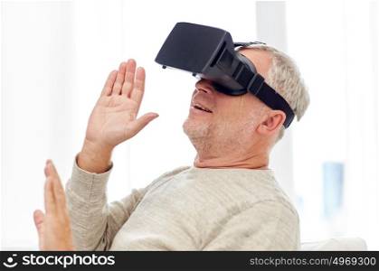 technology, augmented reality, gaming, entertainment and people concept - senior man with virtual headset or 3d glasses playing videogame at home. old man in virtual reality headset or 3d glasses