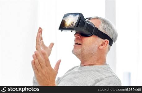 technology, augmented reality, gaming, entertainment and people concept - senior man with singapore city on virtual headset or 3d glasses screen playing videogame. old man in virtual reality headset or 3d glasses