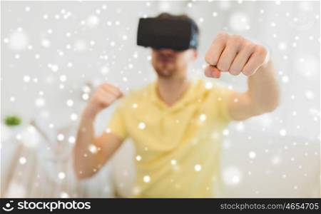 technology, augmented reality, gaming, entertainment and people concept - young man with virtual headset or 3d glasses playing combat game and fighting over snow