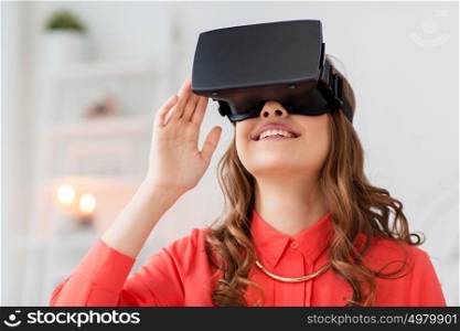 technology, augmented reality, gaming, entertainment and people concept - young man with virtual headset or 3d glasses playing videogame at home. happy woman in virtual reality headset at home