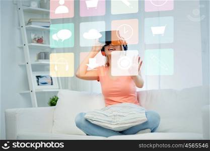 technology, augmented reality, multimedia and people concept - happy young woman in virtual headset or 3d glasses and headphones playing game at home looking at menu icons