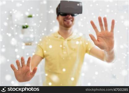 technology, augmented reality, winter, christmas and people concept - close up of happy young man with virtual headset or 3d glasses playing videogame at home over snow