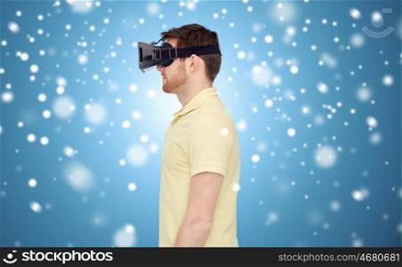 technology, augmented reality, winter, christmas and people concept - young man with virtual headset or 3d glasses over blue background and snow