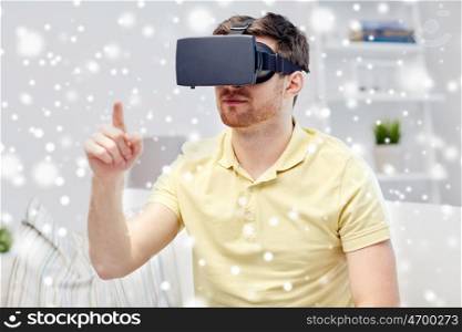 technology, augmented reality, winter, christmas and people concept - young man with virtual headset or 3d glasses playing video game over snow