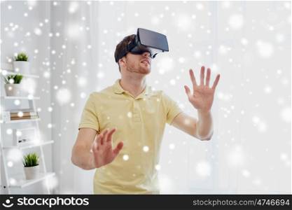 technology, augmented reality, winter, christmas and people concept - young man with virtual headset or 3d glasses playing video game over snow