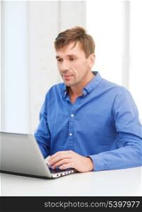technology, business and lifestyle concept - man working with laptop at home
