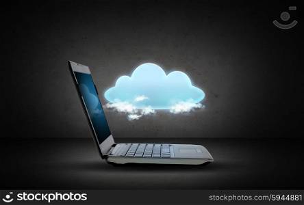 technology, cloud computing and data transfer concept - open laptop computer with cloud projection over dark gray background