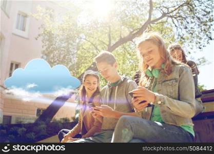 technology, cloud computing and people concept - group of happy teenage friends with smartphone and headphones outdoors. teenage friends with smartphone and headphones. teenage friends with smartphone and headphones
