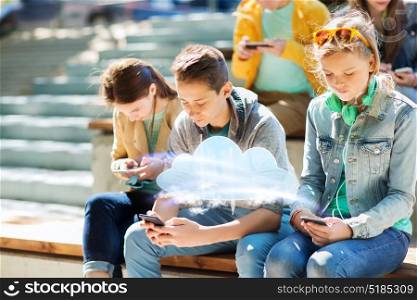 technology, cloud computing and people concept - teenage friends with smartphones outdoors. teenage friends with smartphones outdoors