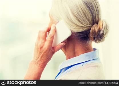 technology, communication, age and people concept - close up of senior woman with smartphone calling at home