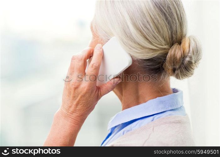 technology, communication, age and people concept - close up of senior woman with smartphone calling at home