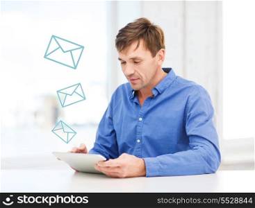 technology, communication and lifestyle concept - handsome man working with tablet pc at home