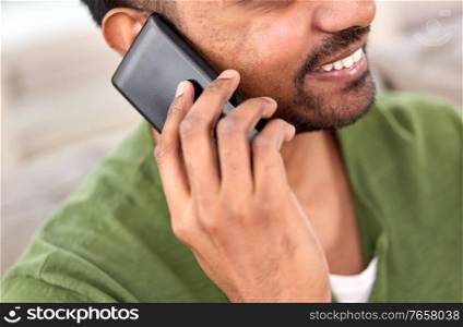 technology, communication and people concept - close up of happy smiling indian man calling on smartphone. close up of happy indian man calling on smartphone