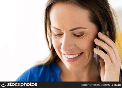 technology, communication and people concept - close up of happy smiling woman calling on smartphone. close up of happy woman calling on smartphone