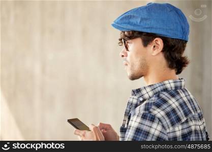 technology, communication and people concept - close up of man texting message on smartphone