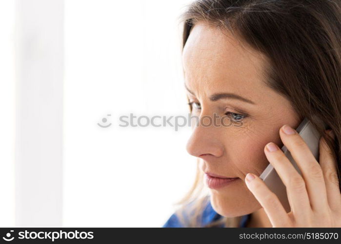 technology, communication and people concept - close up of smiling happy woman calling on smartphone. close up of woman calling on smartphone