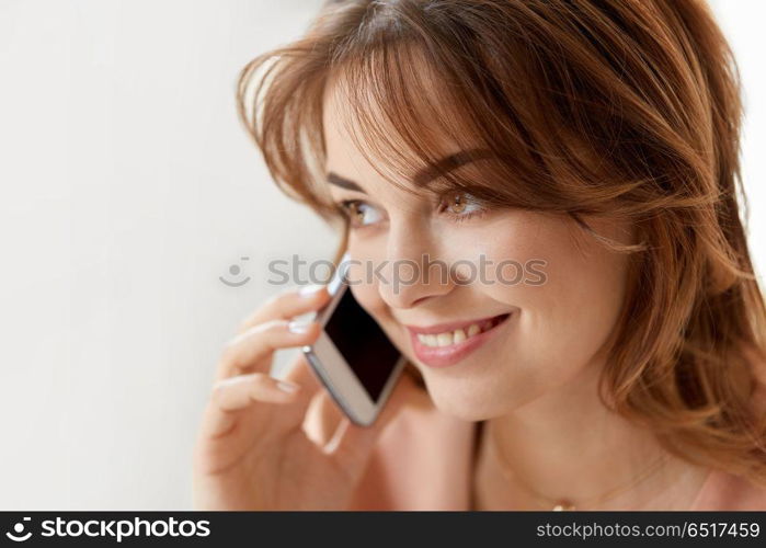 technology, communication and people concept - close up of smiling woman calling on smartphone. close up of smiling woman calling on smartphone. close up of smiling woman calling on smartphone