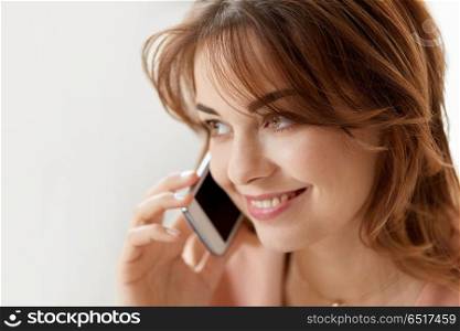 technology, communication and people concept - close up of smiling woman calling on smartphone. close up of smiling woman calling on smartphone. close up of smiling woman calling on smartphone
