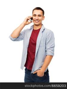 technology, communication and people concept - happy smiling young man calling on smartphone over white background. happy young man calling on smartphone