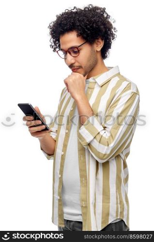 technology, communication and people concept - puzzled young man with smartphone over white background. puzzled young man with smartphone