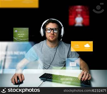 technology, communication, mass media, virtual reality and people concept - young man in headset and eyeglasses with pc computer keyboard over virtual screens