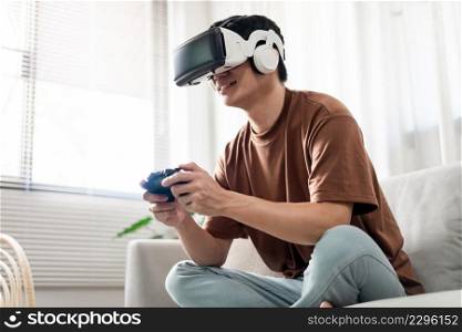 Technology Concept A person wearing a virtual reality headset and holding a black console game while sitting on the sofa.
