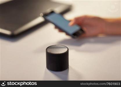 technology concept - smart speaker on table at office. smart speaker on table at office