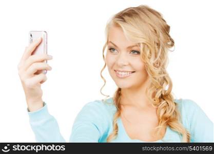 technology concept - smiling woman taking photo with smartphone