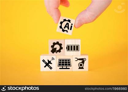 ?. Technology concept with icons on wooden cubes, yellow background.