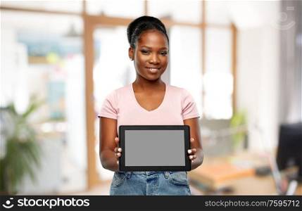 technology, corporate and people concept - happy smiling african american woman showing tablet pc computer over office background. african american woman with tablet pc at office