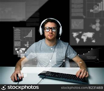 technology, cyberspace, virtual reality and people concept - hacker man in headset and eyeglasses with pc computer keyboard over virtual screens