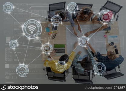 Technology digital virtual screen and Wireless communication connecting over Top view scene of Asian and Multiethnic Business people with brainstorming and pointing to the target in modern workplace