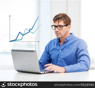 technology, economy, business and office concept - man in eyeglasses working with laptop at home