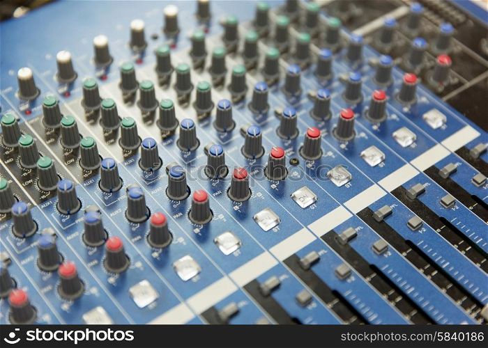 technology, electronics and equipment concept - control panel at recording studio or radio station