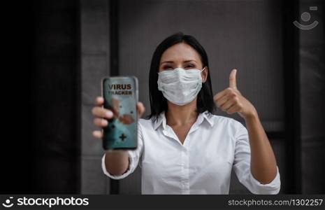 Technology for Covid-19 or Corona Virus Situation Concept. Business Woman with Medical Mask Presenting the Application for Virus Tracking on Mobile Phone. Helping People to Deal with it