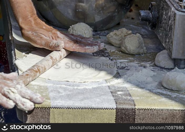 Technology for the manual preparation of dough for pizza with a rolling pin and flour, Sofia, Bulgaria