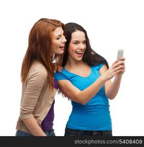 technology, friendship and people concept - two smiling teenagers with smartphone
