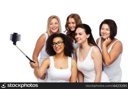 technology, friendship, body positive and people concept - group of happy women in white underwear taking picture with smartphoone on selfie stick