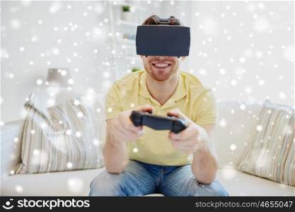 technology, gaming, augmented reality and people concept - happy young man with virtual headset or 3d glasses playing video game with controller gamepad at home over snow