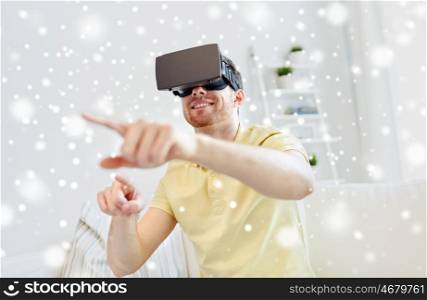 technology, gaming, augmented reality, entertainment and people concept - happy young man with virtual headset or 3d glasses playing video game over snow