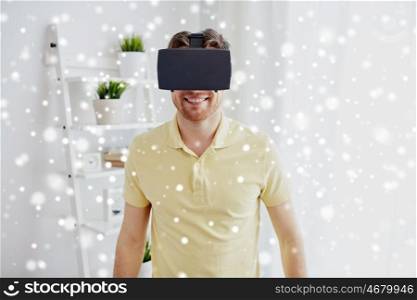 technology, gaming, augmented reality, entertainment and people concept - happy young man with virtual headset or 3d glasses playing video game over snow