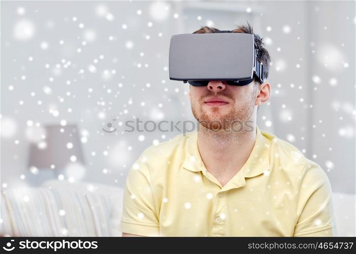 technology, gaming, augmented reality, entertainment and people concept - young man with virtual headset or 3d glasses playing video game over snow