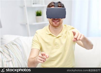 technology, gaming, entertainment and people concept - happy young man with virtual reality headset or 3d glasses playing video game