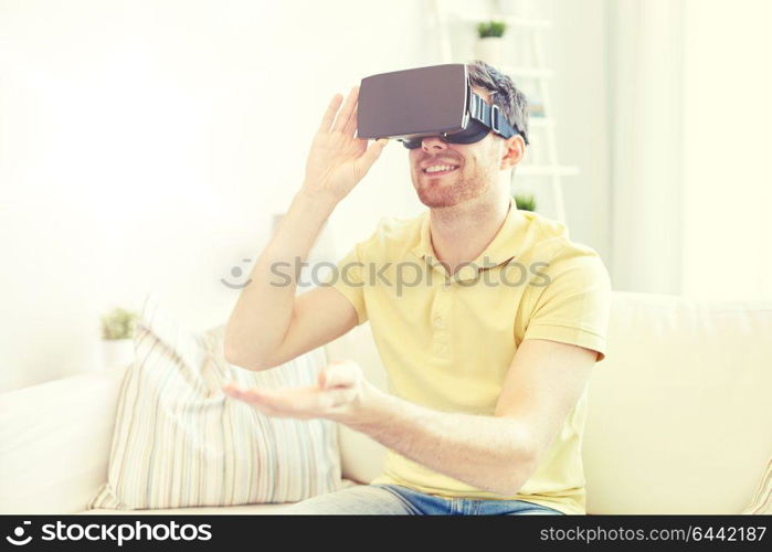 technology, gaming, entertainment and people concept - happy young man with virtual reality headset or 3d glasses playing video game. young man in virtual reality headset or 3d glasses