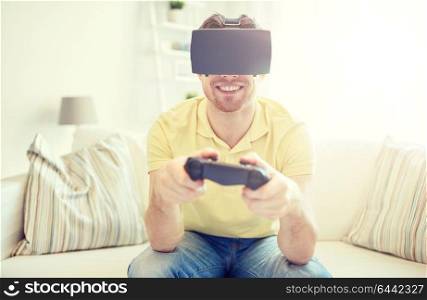 technology, gaming, entertainment and people concept - happy young man with virtual reality headset or 3d glasses playing video game with controller gamepad at home. man in virtual reality headset with controller