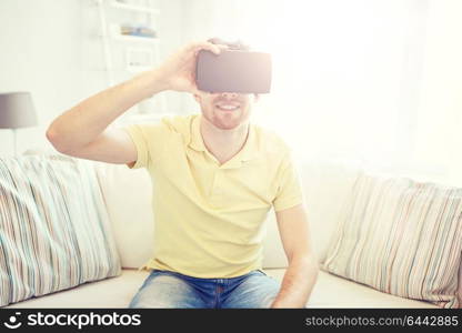 technology, gaming, entertainment and people concept - happy young man with virtual reality headset or 3d glasses playing video game. young man in virtual reality headset or 3d glasses