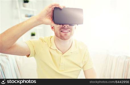 technology, gaming, entertainment and people concept - happy young man with virtual reality headset or 3d glasses playing video game. young man in virtual reality headset or 3d glasses