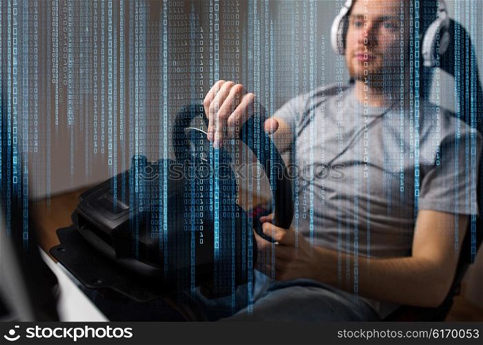 technology, gaming, entertainment, let&amp;#39;s play and people concept - close up of young man in headphones with pc computer playing car racing video game at home and steering wheel